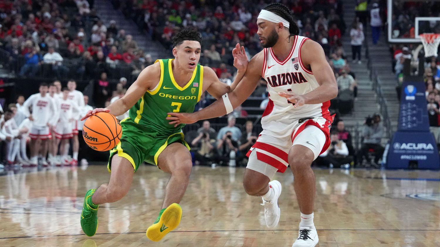 Oregon Ducks guard Jackson Shelstad dribbles the ball against Arizona Wildcats guard Kylan Boswell.